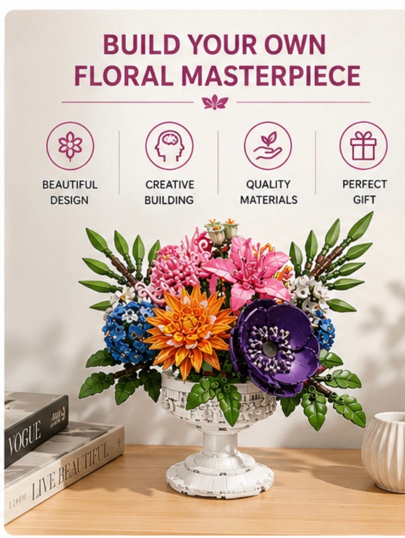 A floral arrangement in a white pedestal vase sits on a wooden table with decorative books and a small vessel nearby. Above the arrangement, text reads 'BUILD YOUR OWN FLORAL MASTERPIECE' with four pink icons and labels: Beautiful Design, Creative Building, Quality Materials, and Perfect Gift.