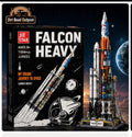 JIE STAR Falcon Heavy building block set by Dirt Road Outpost, showing the black retail box with white and red text alongside the assembled model rocket on a launch stand against a starry space background with Earth visible.