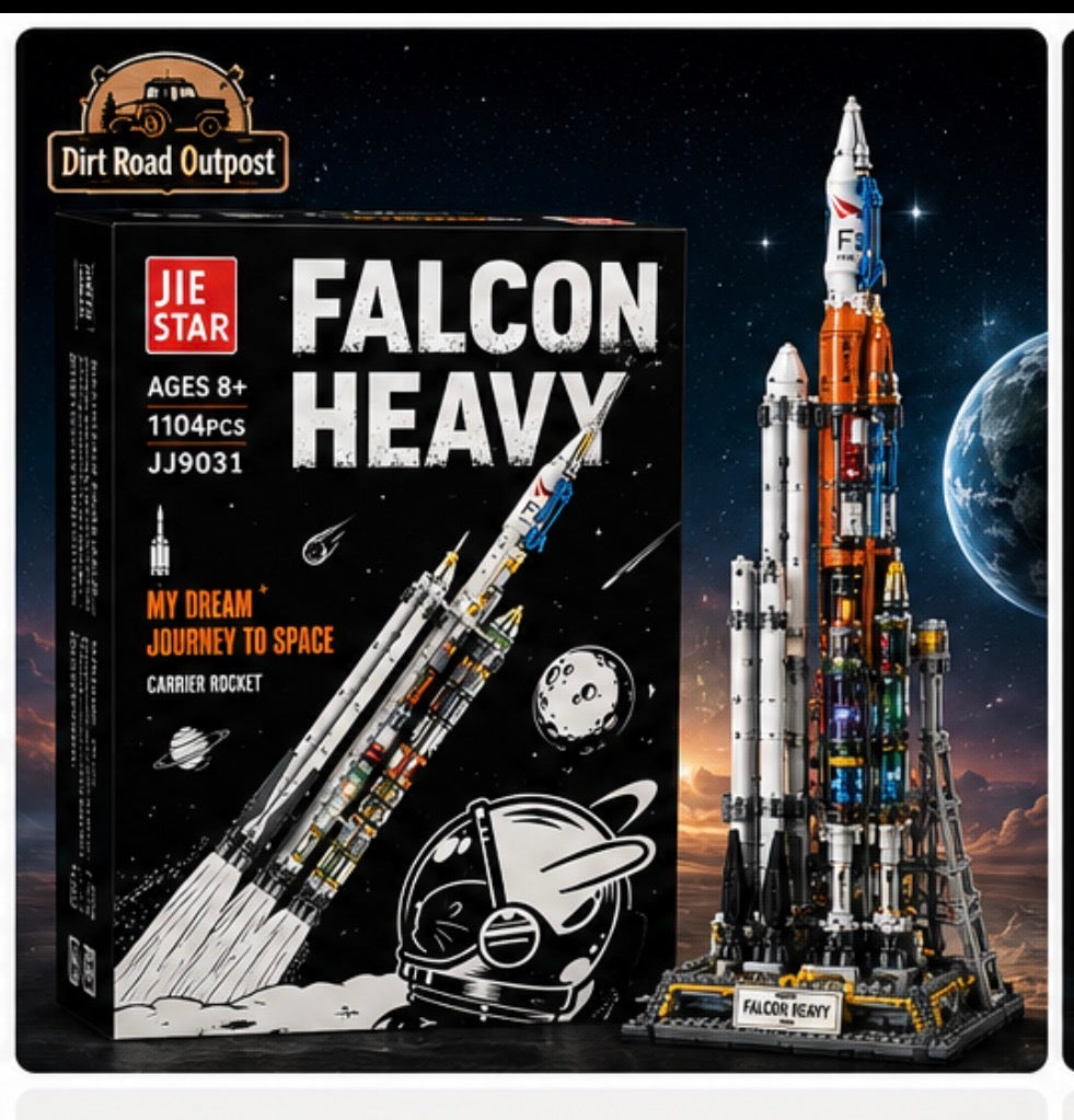 JIE STAR Falcon Heavy building block set by Dirt Road Outpost, showing the black retail box with white and red text alongside the assembled model rocket on a launch stand against a starry space background with Earth visible.