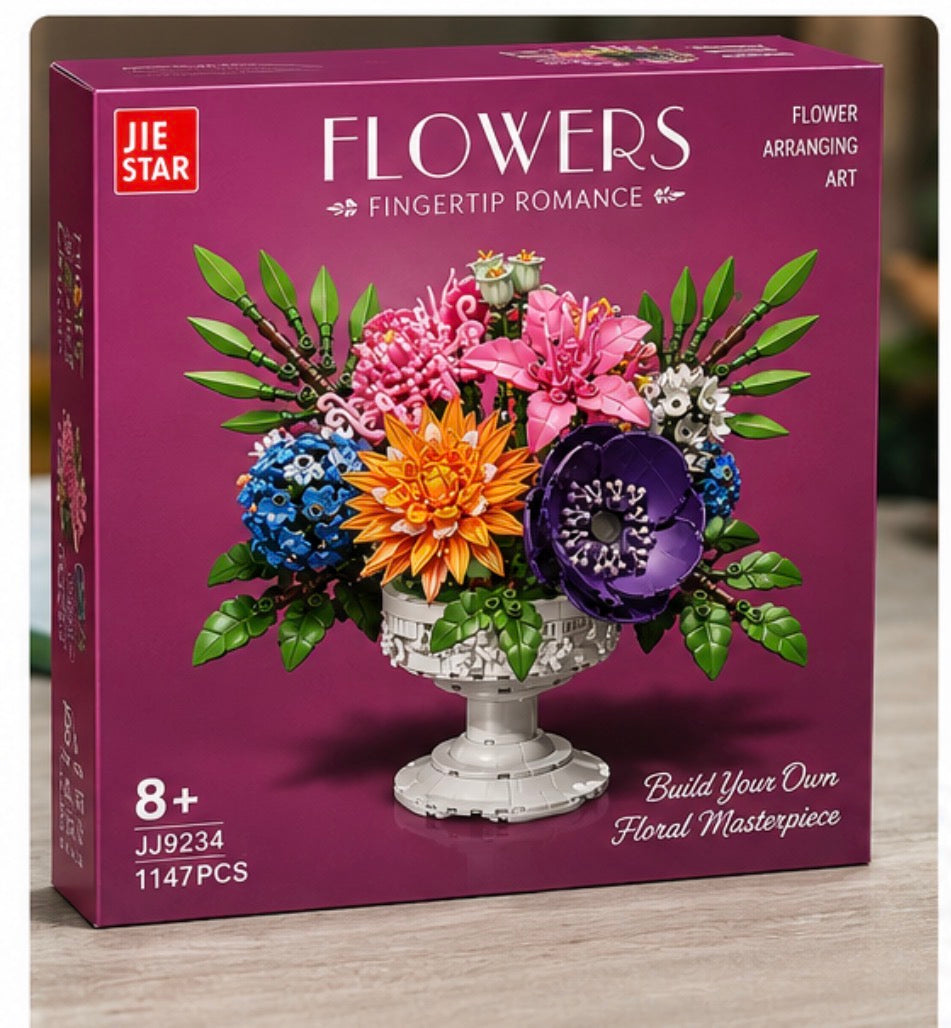 JIE STAR FLOWERS fingertip romance flower arranging art building block set in a deep magenta box, featuring a colorful 3D-rendered floral arrangement in a white pedestal vase.